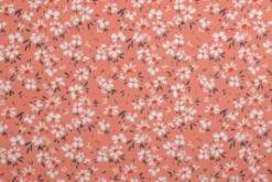 Lycra - Small White Flowers on Soft Orange